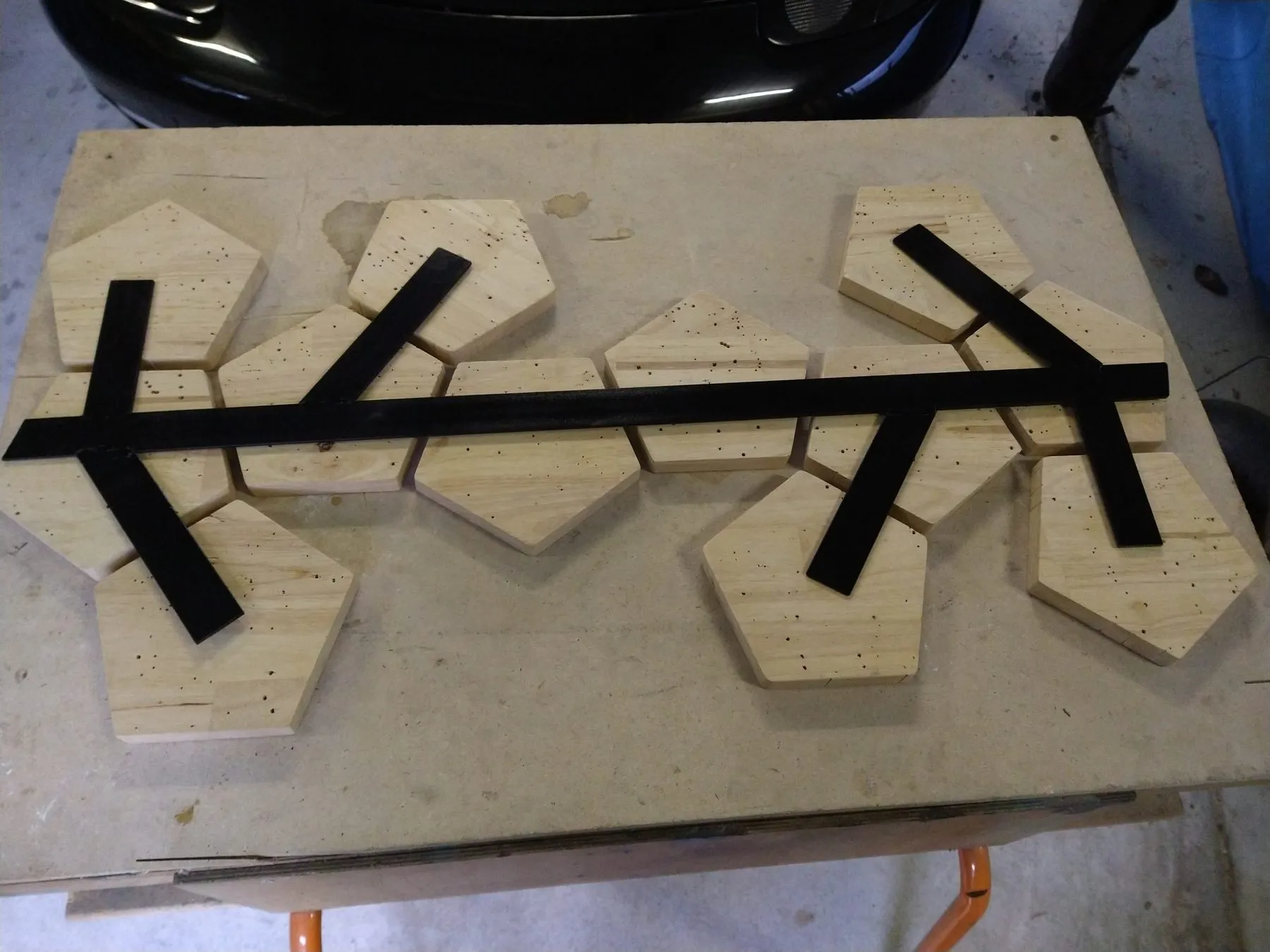 Pentagons laid out in a row with the black zodiac band across them