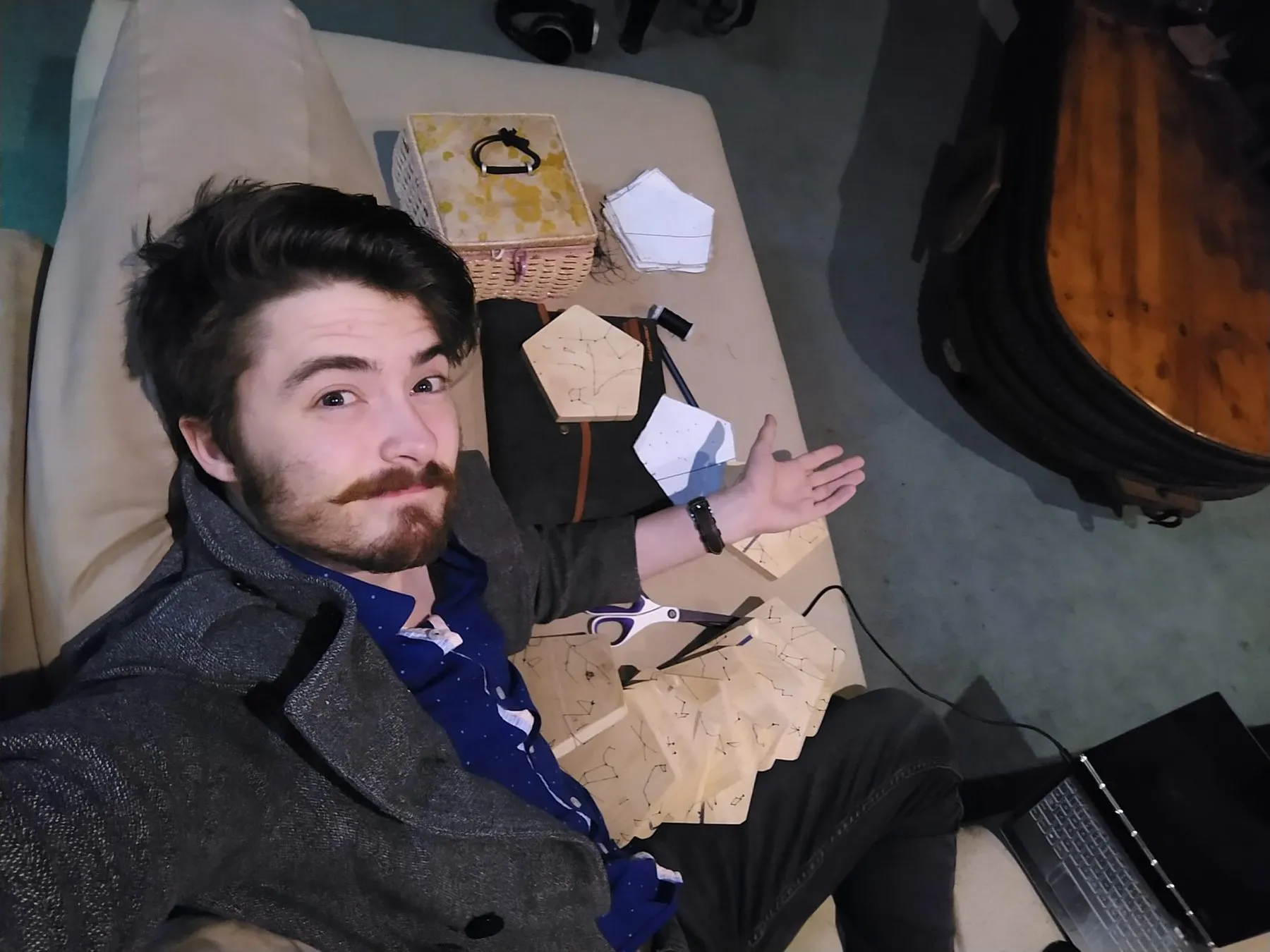 Geoff lying back in a chair holding one of the pentagons