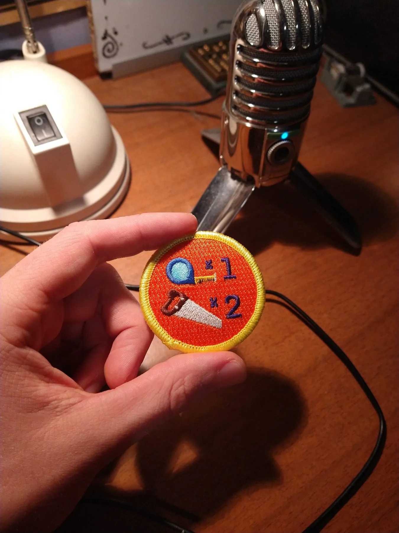 The "re-drilled" demerit badge from Adam Savage's Tested store